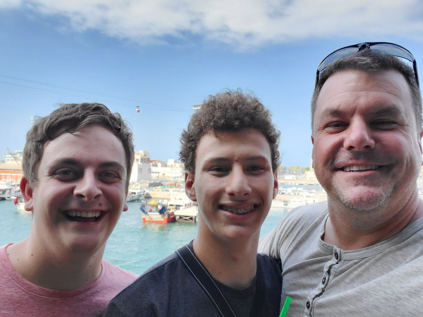Roger and his sons smiling by the Barcelona waterfront