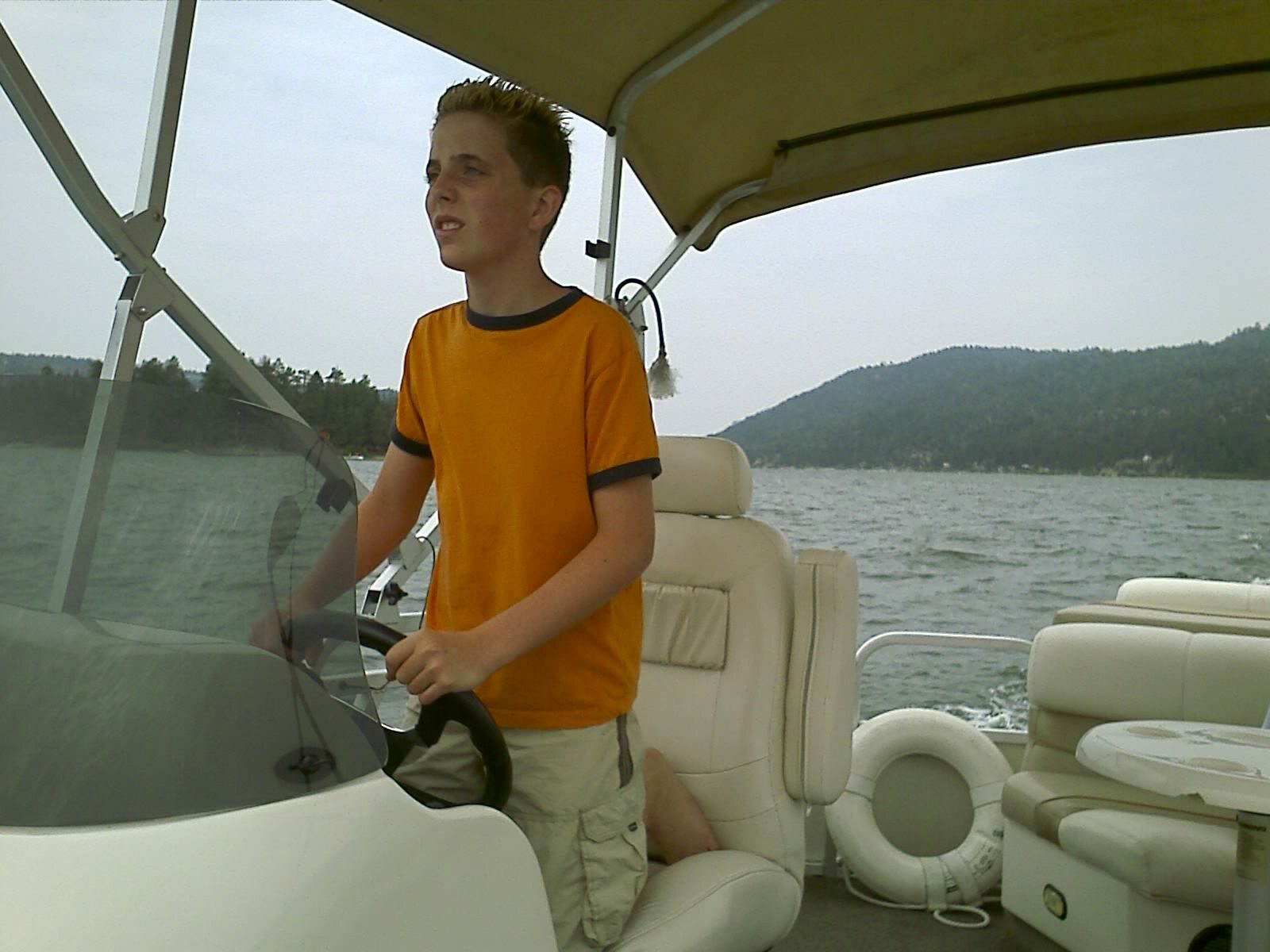 One of Roger's sons steering a boat on Big Bear Lake