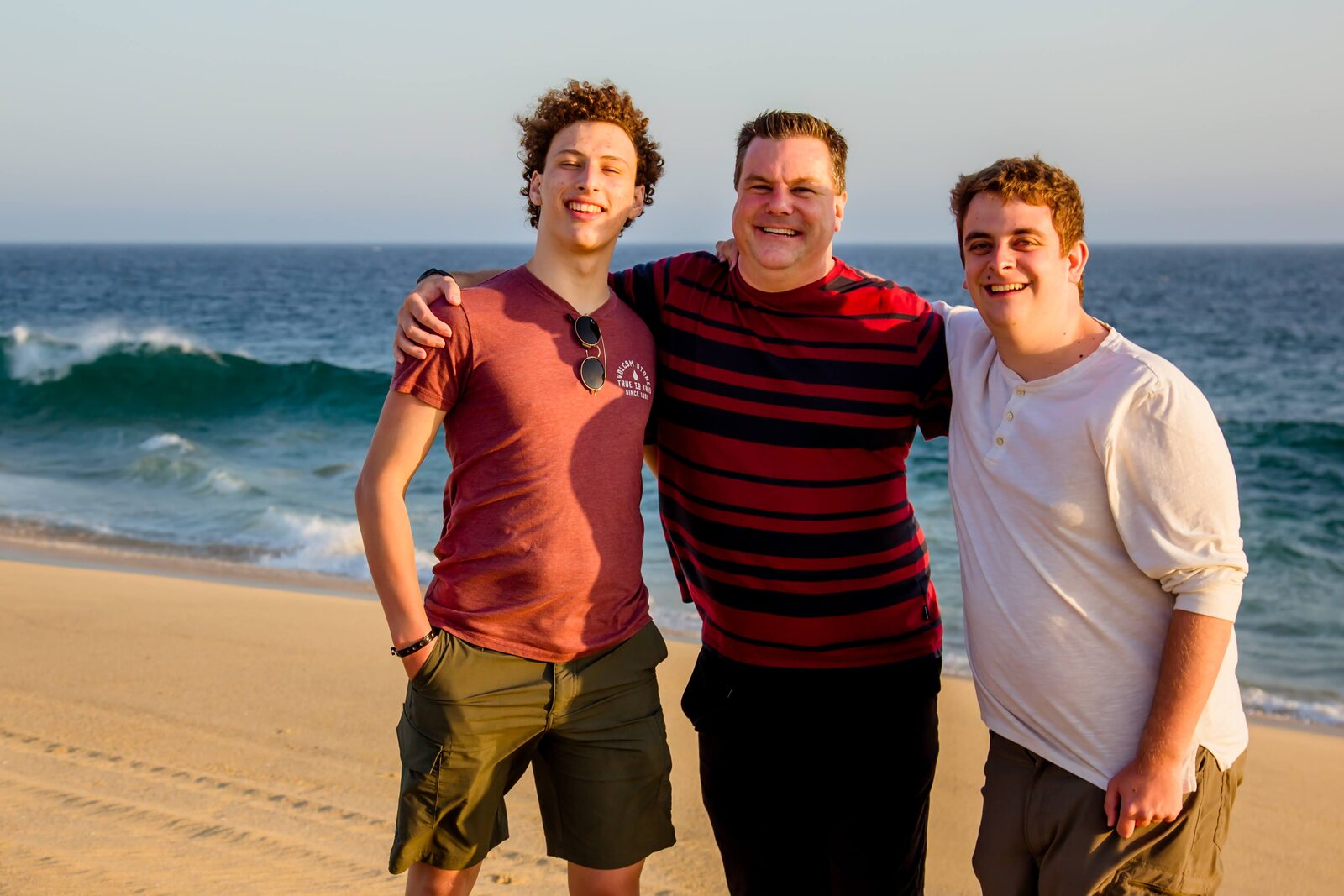 Roger and his sons together on a Los Cabos beach at sunset