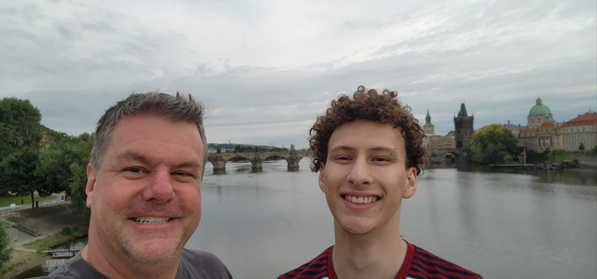 Roger and a son beside the Vltava in Prague