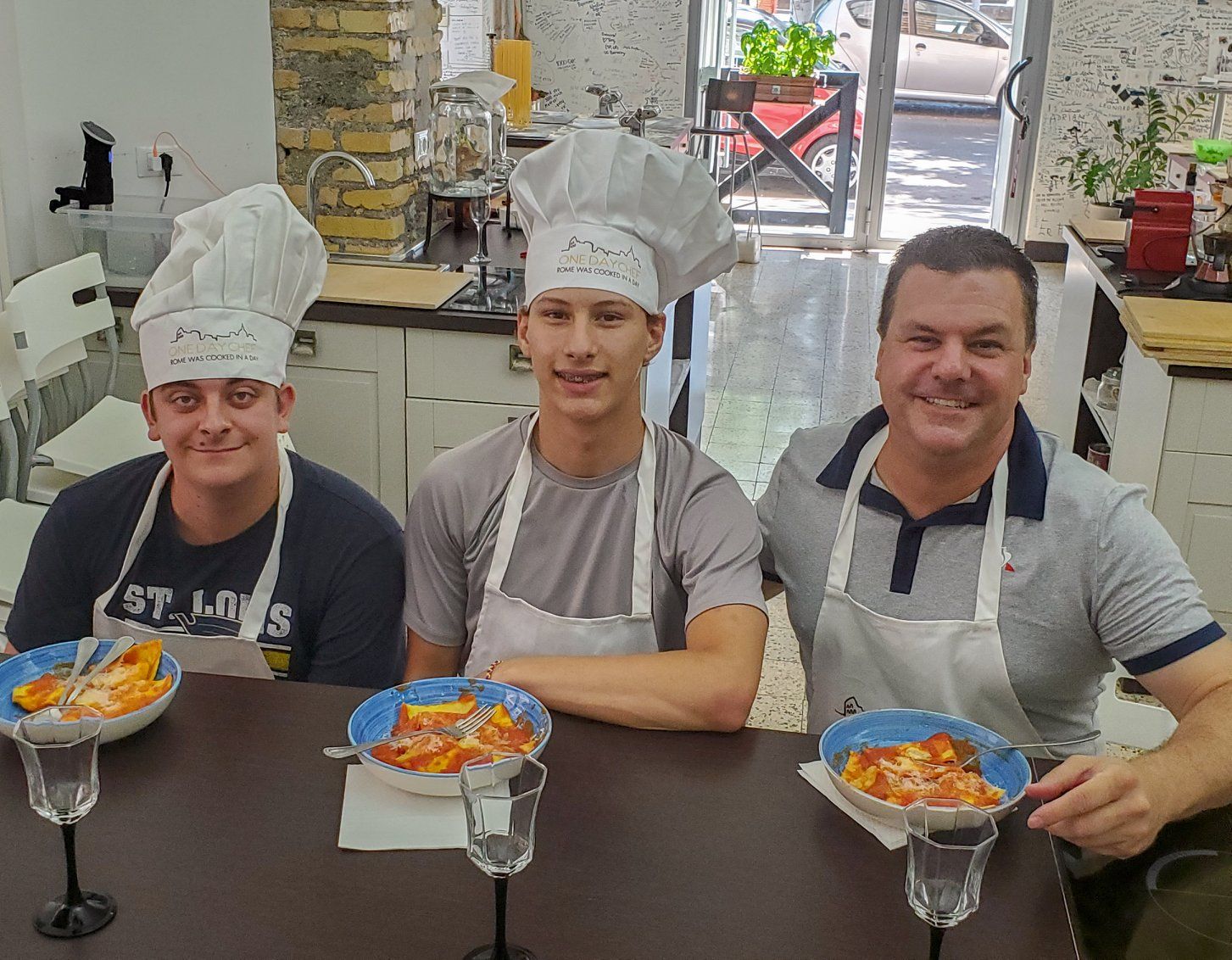 Roger and his sons at a table with the pasta they made