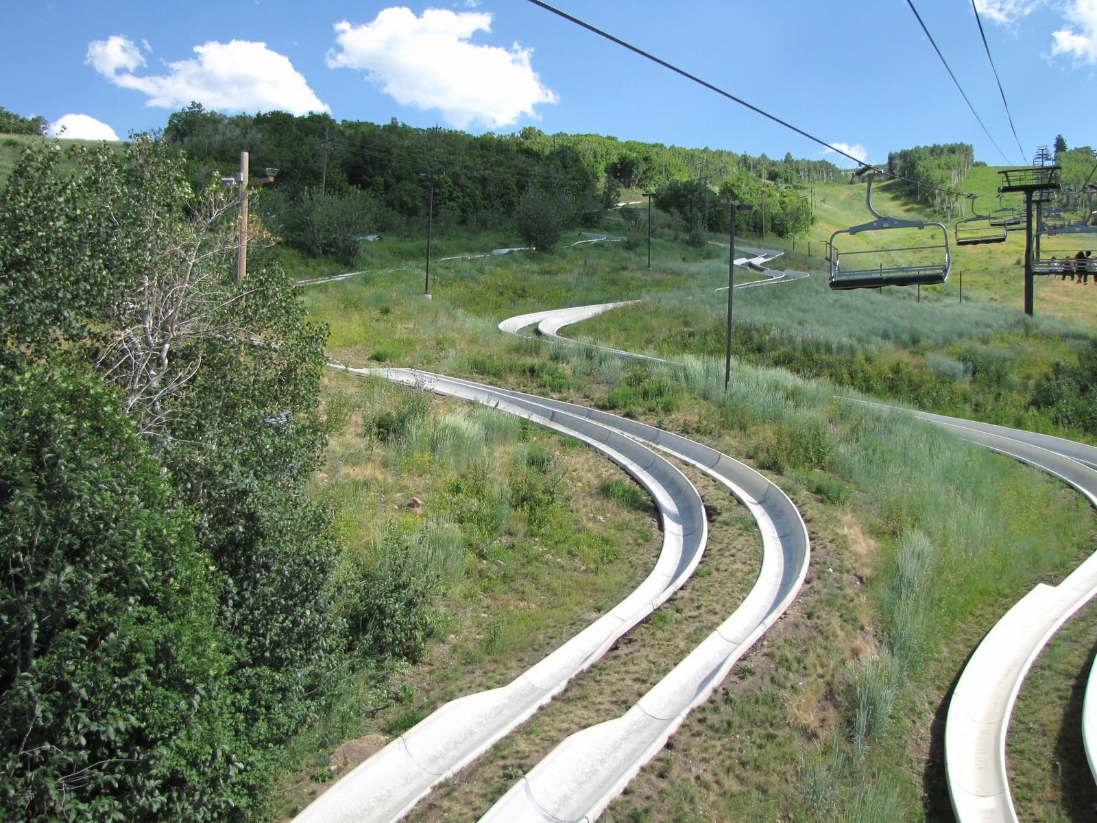 Mountain slide track curving through green Utah hills